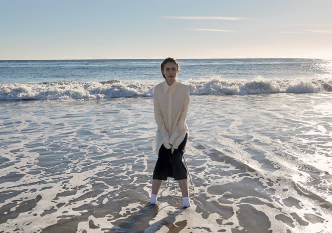 sea nature outdoors water person clothing shorts shoreline beach coast