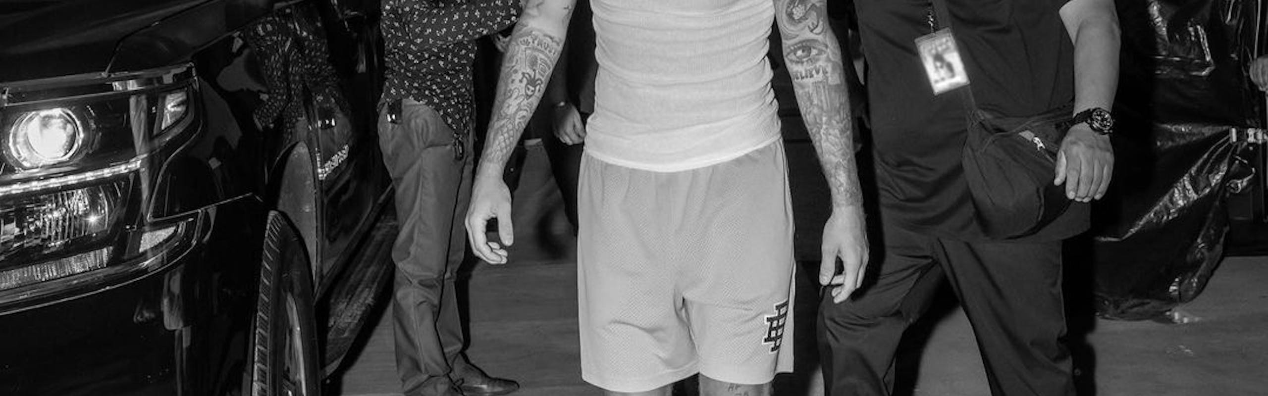 In a black and white photo, Justin Bieber sports a white tank and shorts.