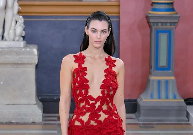 model in red cutout dress