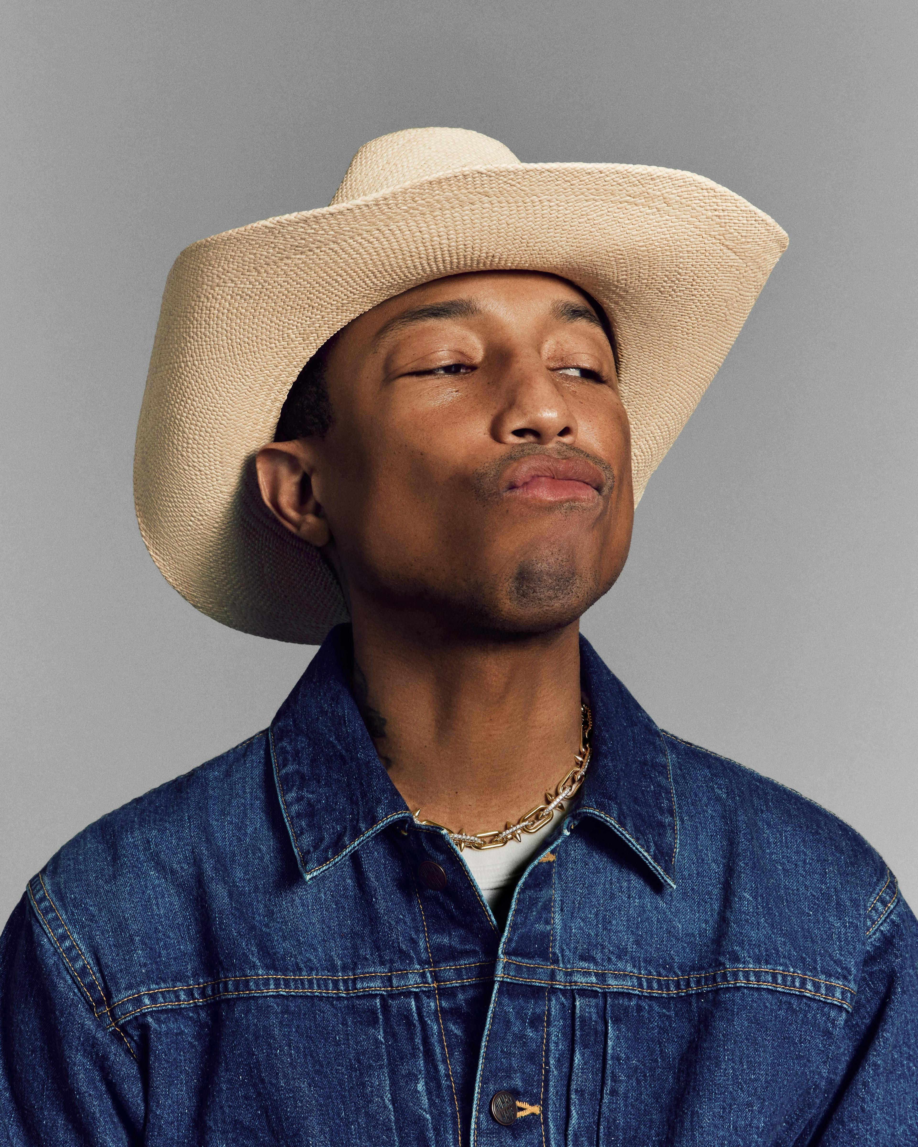 pharrell williams wearing a denim jacket, cowboy hat, and tiffany titan jewelry