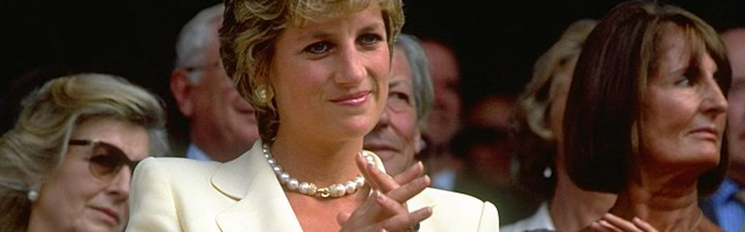 Portrait of Diana, Princess of Wales during the Lawn Tennis Championships at Wimbledon in 1995 in a yellow suit. Getty Images.