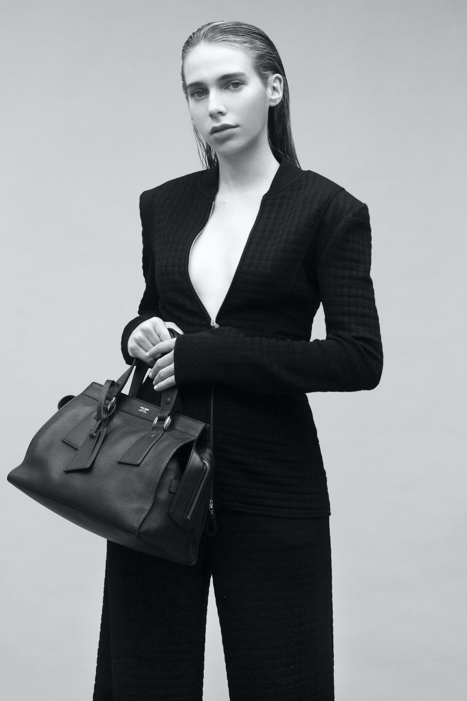 clothing sleeve overcoat coat female person handbag long sleeve suit woman