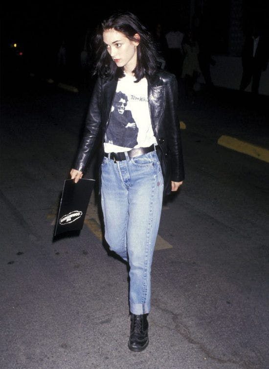 winona ryder in a black leather jacket, white graphic tee, and jeans