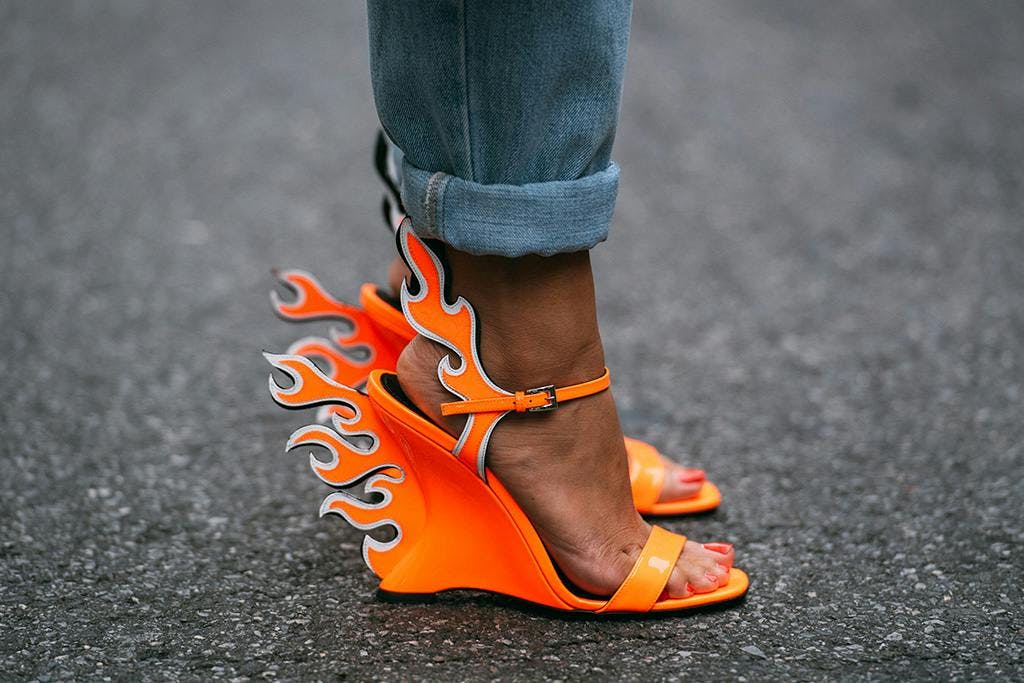 a pair of orange heels with flames