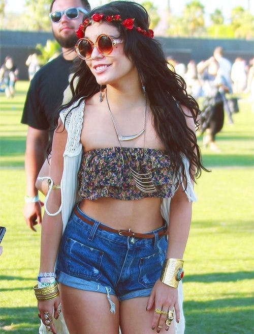 vanessa hudgens at coachella in a flower crown and crop top and cutoff jean shorts