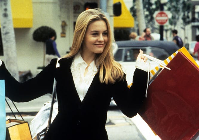 Cher from Clueless holding shopping bags
