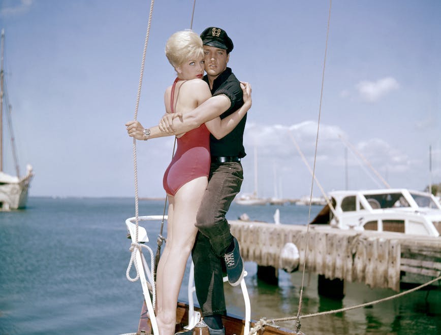 1960s two people young adult man young adult woman caucasian ethnicity movie set sailboat actress actor performing arts singer music celebrities hugging american movie film still hawaii elvis presley stella stevens person watercraft vehicle transportation water clothing waterfront pier wood boat