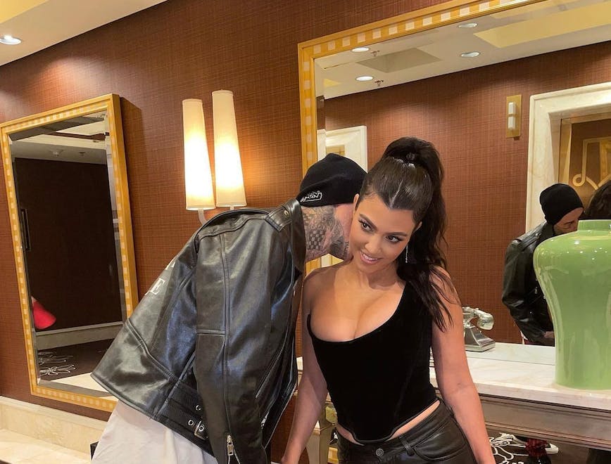 Kourtney Kardashian and Travis Barker holding hands