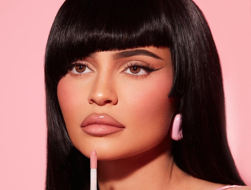 Kylie Jenner applying lip gloss in a Kylie Cosmetics campaign
