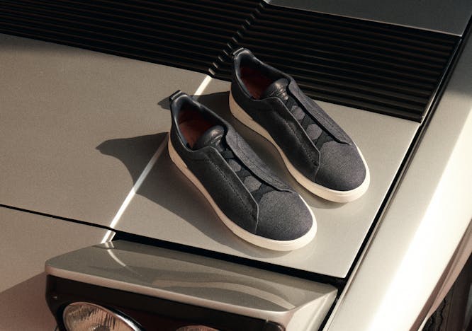 Photo of black Zegna Triple Stitch sneakers on a white car