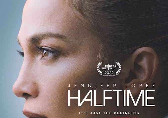 Jennifer Lopez poses in front of blue backdrop for her 'Halftime' movie poster 