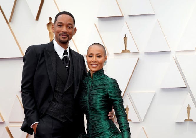 Will Smith in a black tuxedo and Jada Pinkett Smith in a fluffy green gown on the Oscars red carpet