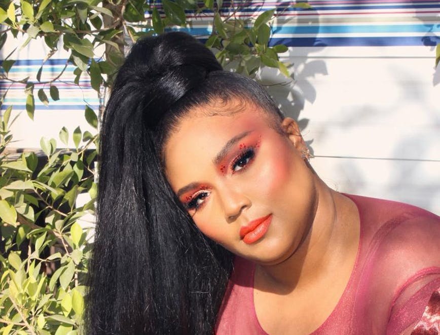 Lizzo sports a chic red ensemble with makeup red eye makeup