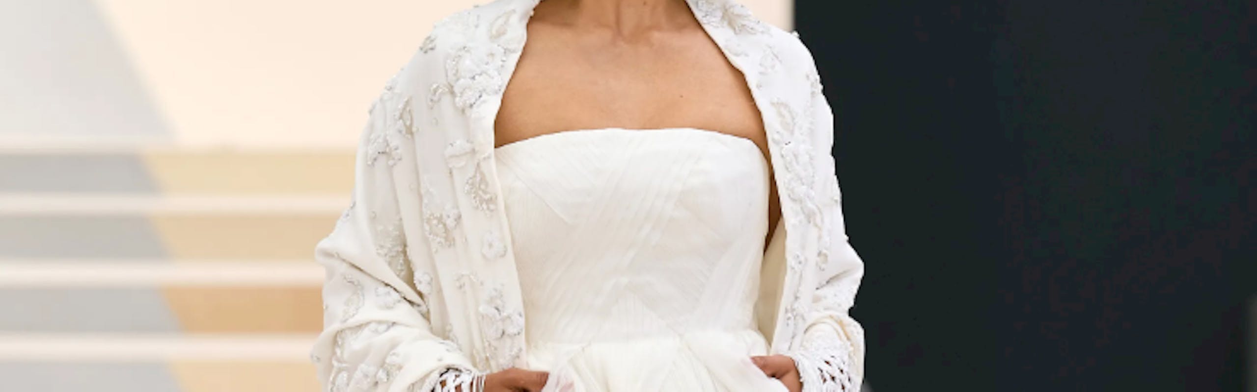 a model wearing a white bridal gown and a bow