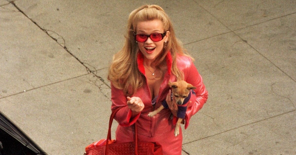 Elle Woods rocking the Barbiecore trend on set of Legally Blonde in a pink leather outfit. 