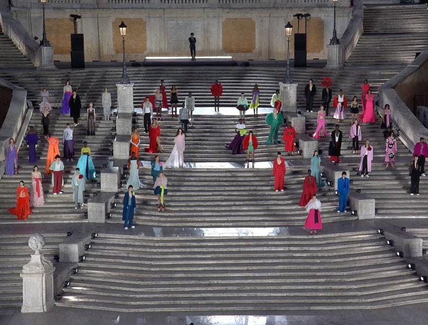 Models in colorful gowns on steps in Rome