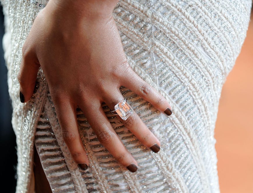 Close-up of Beyonce's hand where here engagement ring is clearly visible. 