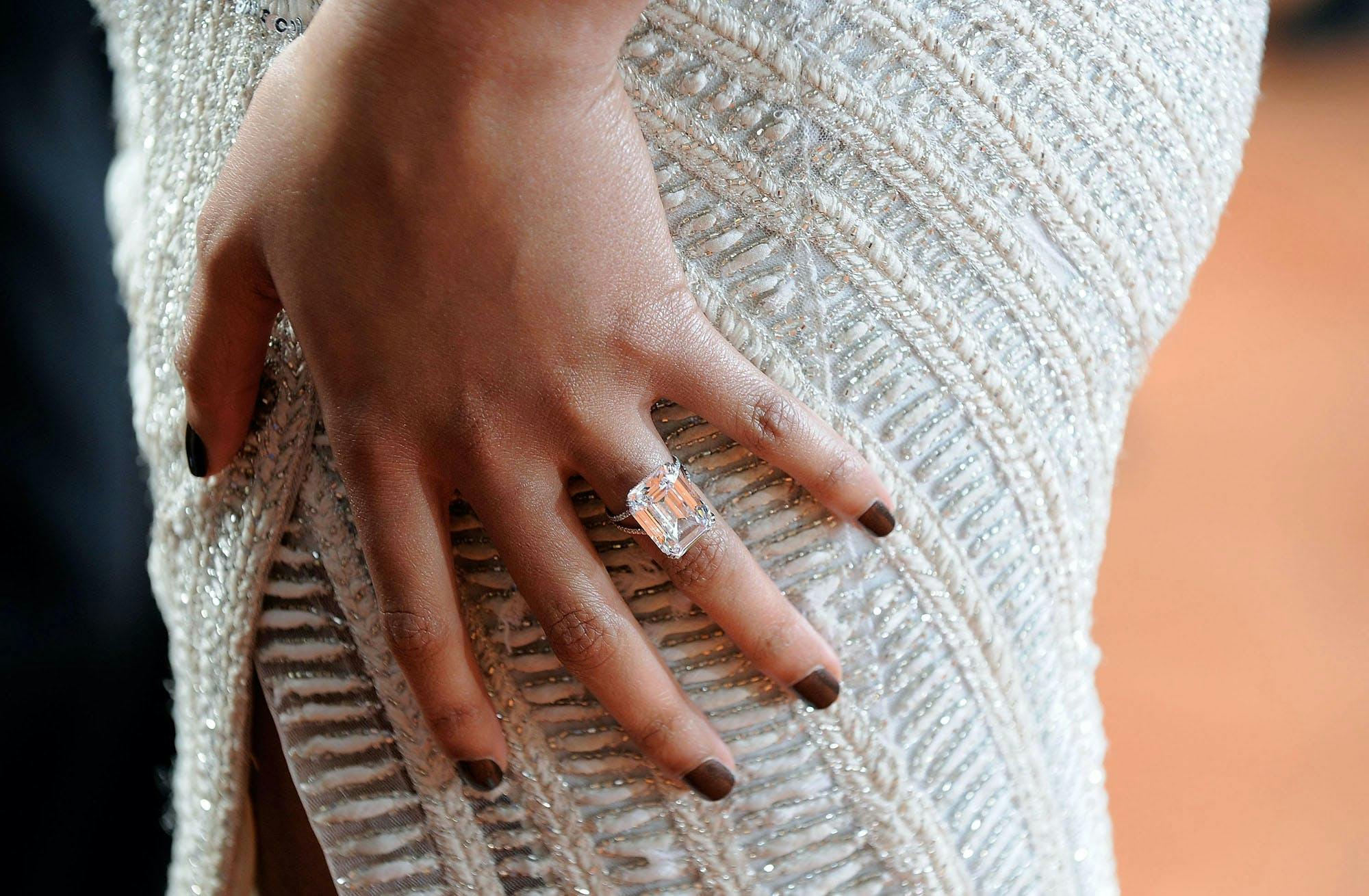 Close-up of Beyonce's hand where here engagement ring is clearly visible. 