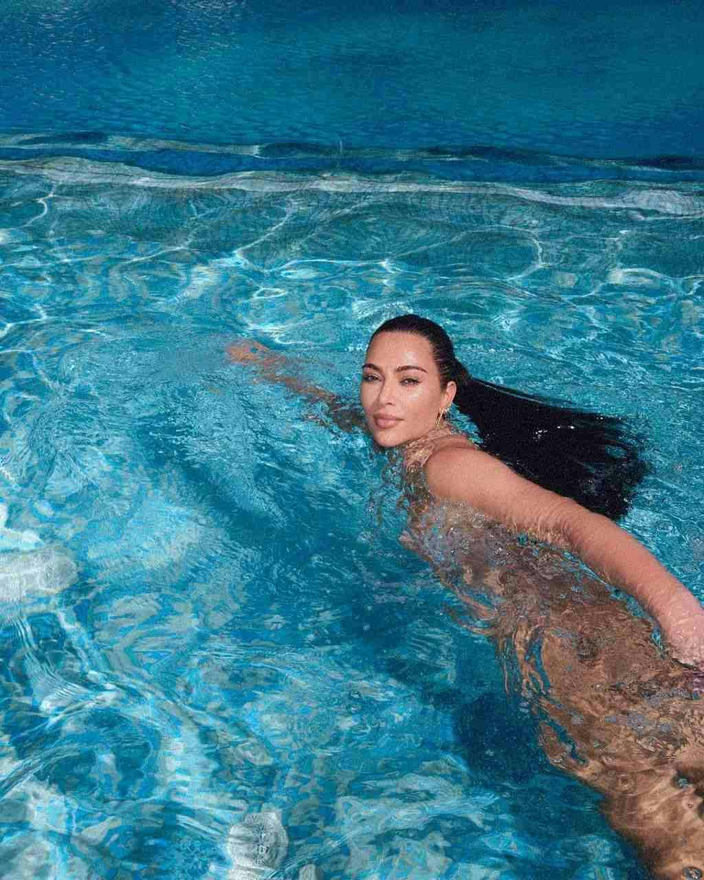 Kim Kardashian swimming in a pool.