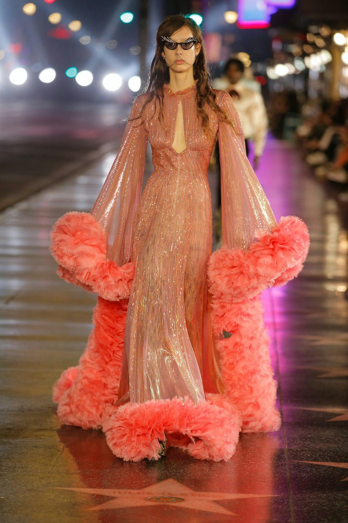 Model for Gucci in a bright coral gown