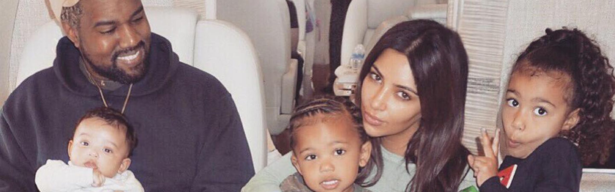 Kim Kardashian with Kanye West with their children, North West, Chicago West, and Saint West on an airplane.