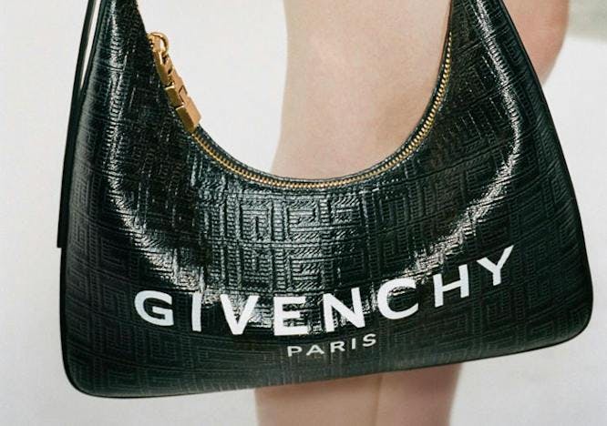 Model holding a Givenchy hobo bag.