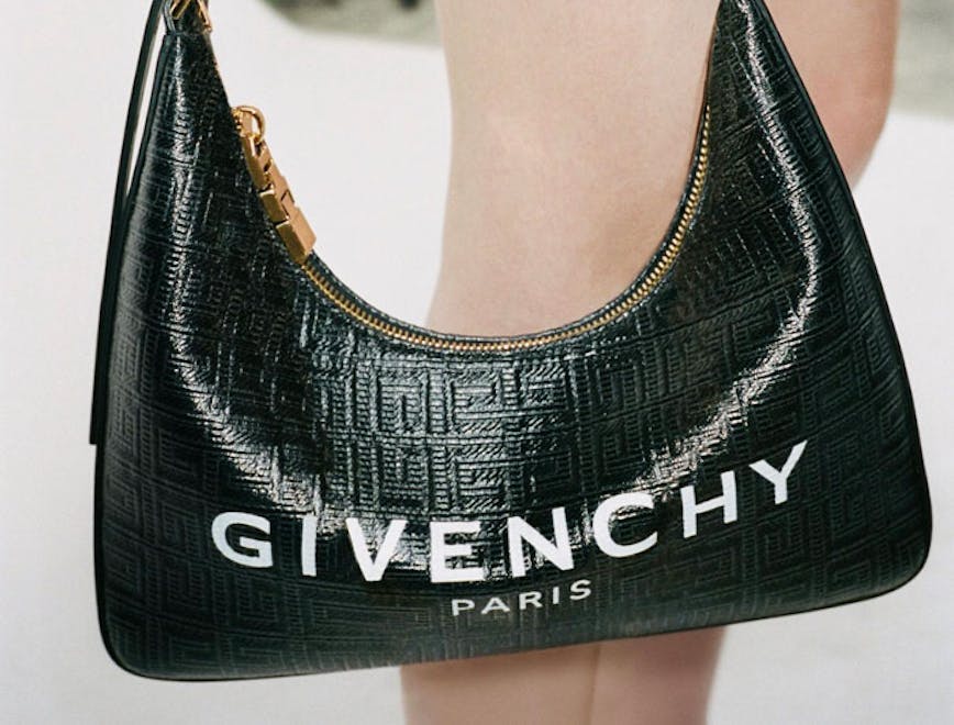 Model holding a Givenchy hobo bag.
