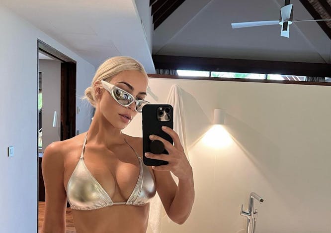 Kim Kardashian takes a mirror pic in a silver bikini.
