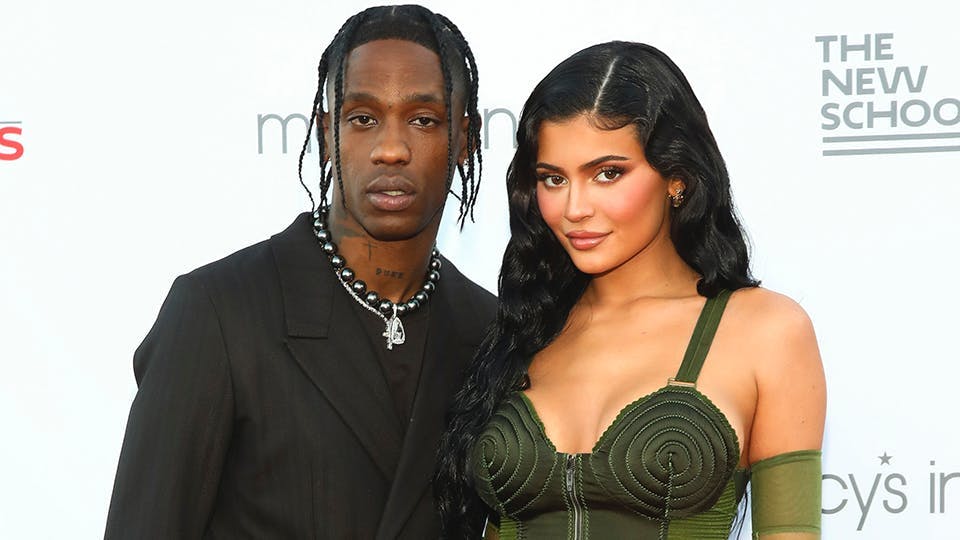 Travis Scott and Kylie Jenner pose for a photo on the red carpet. 