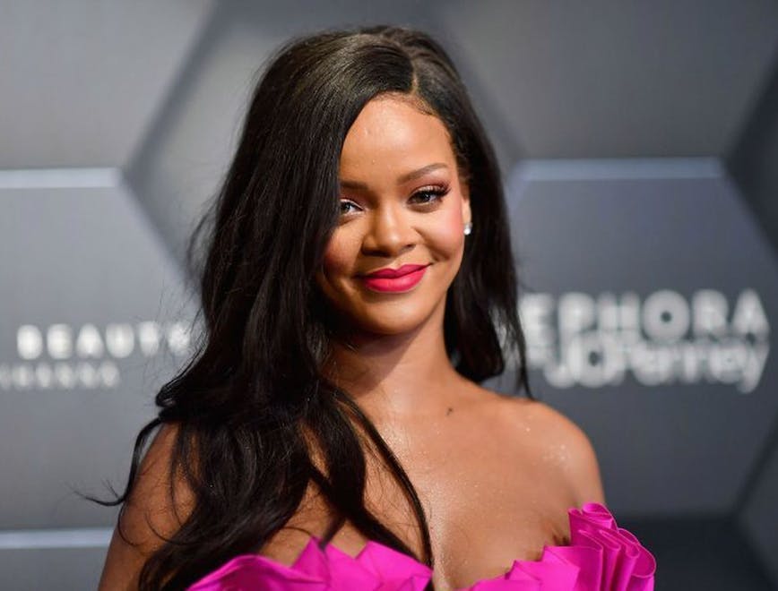 Rihanna wearing a pink top on the Fenty Beauty red carpet