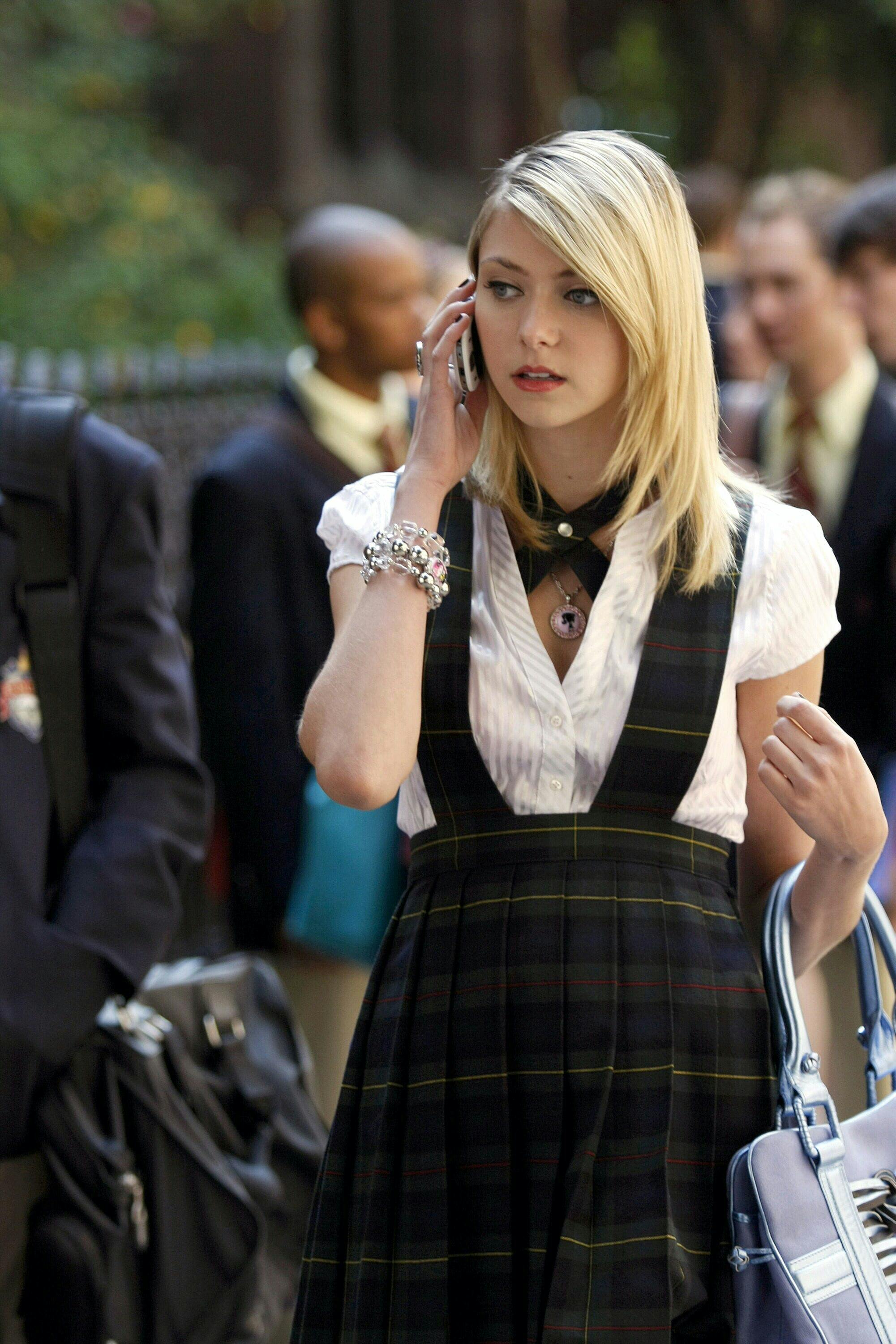 Jenny Humphrey in a plaid skirt/jumpber and a white shirt.