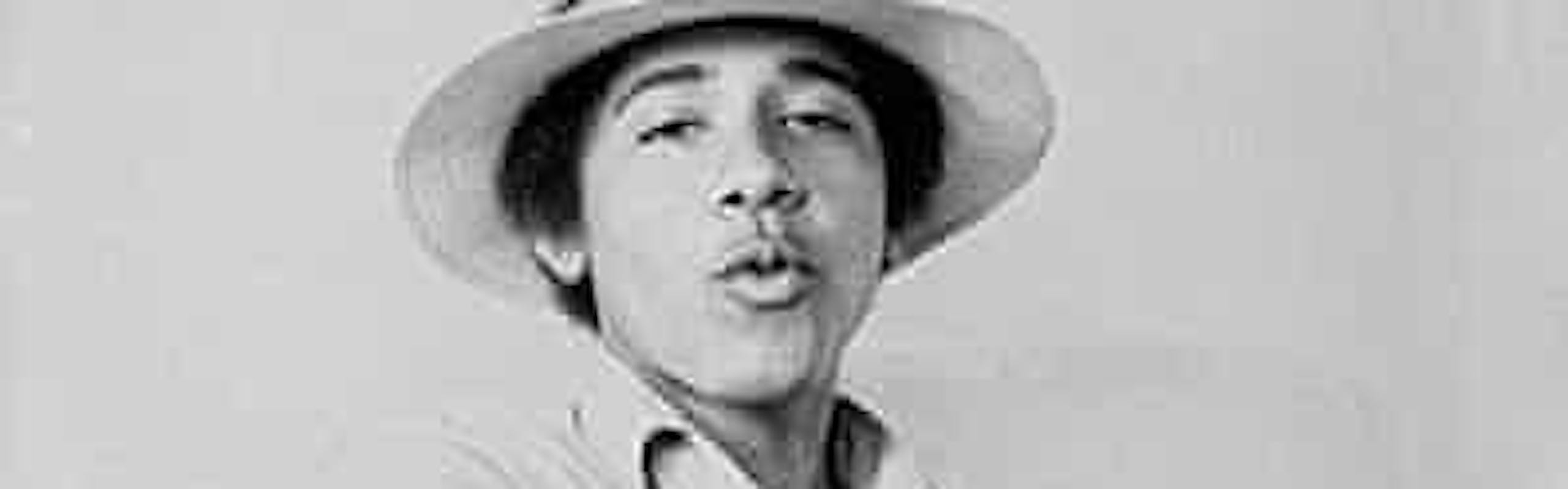 Young Barack Obama wearing a top hat, a polo shirt, and jeans