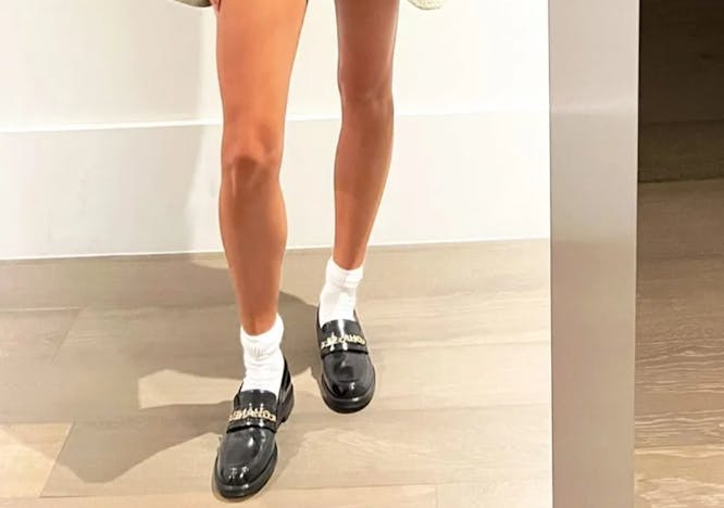 hailey bieber posing with socks and loafers