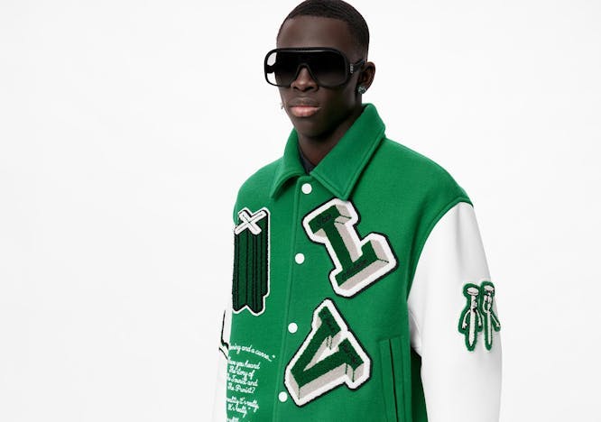 Male model wearing a green Louis Vuitton letterman jacket