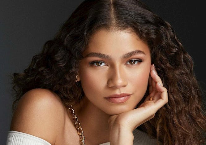 Zendaya in a white top on a black background