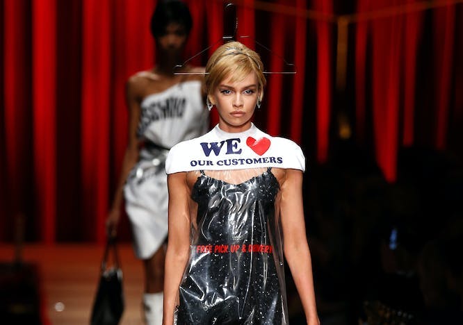 Model wearing the Moschino plastic dry cleaning bag dress