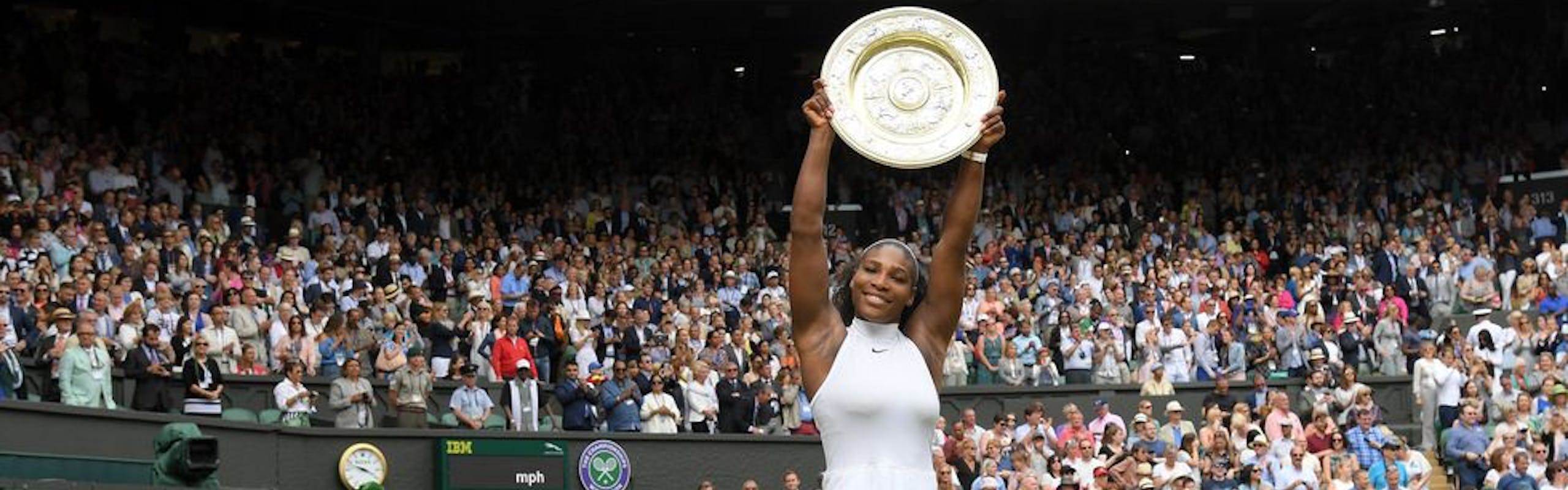 serena williams holding her trophy after wimbledon 2016 in a white dress