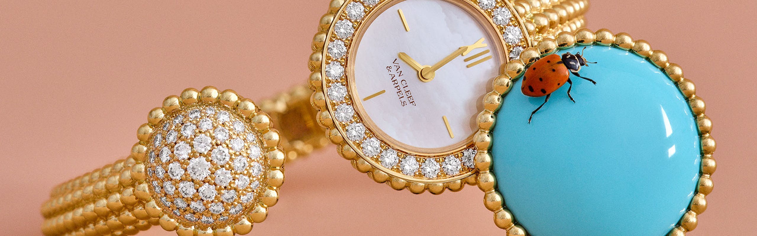 van cleef watch with gold beading and a turquoise watch face cover