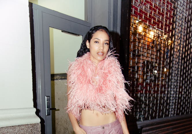 aleali may wearing a pink feathered top