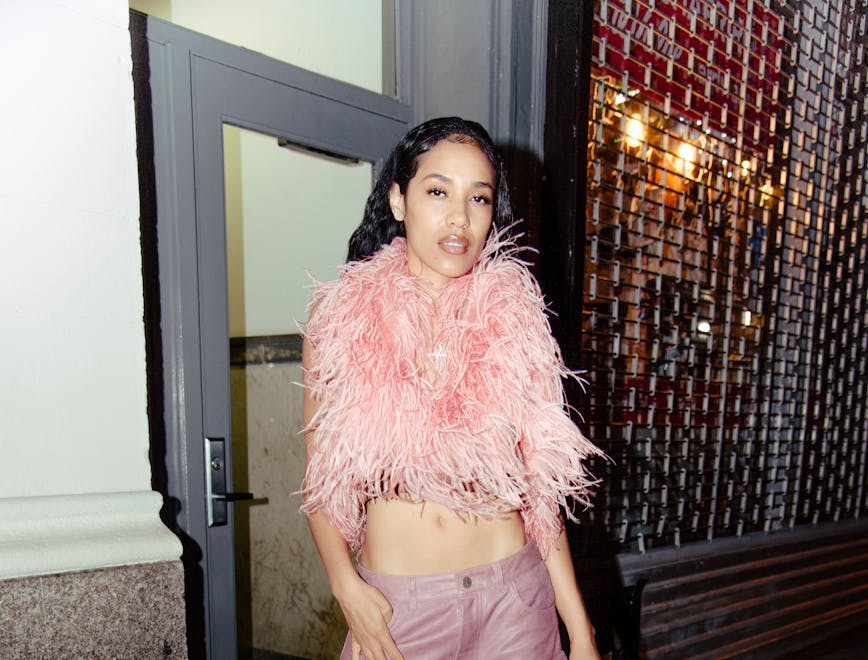 aleali may wearing a pink feathered top