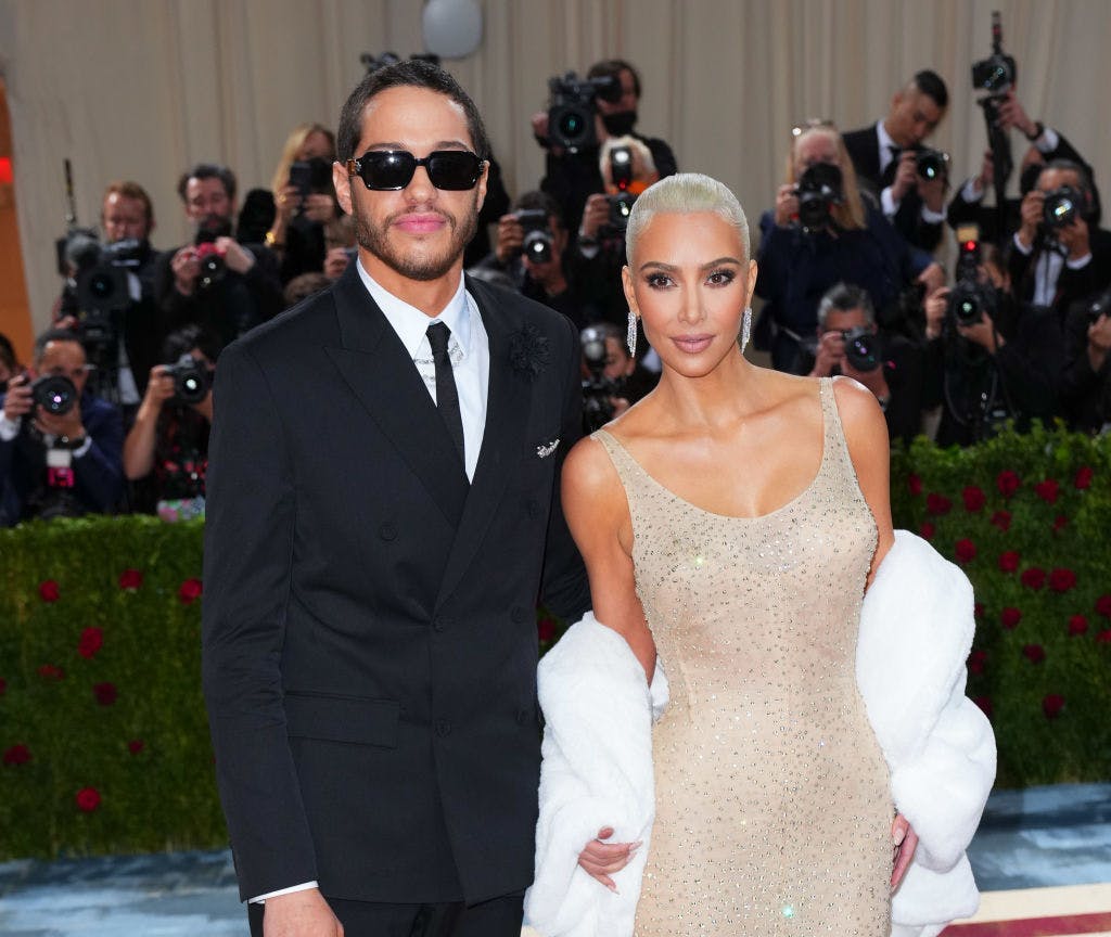 Pete Davidson in a black suit and Kim Kardashian in a sequined nude gown.