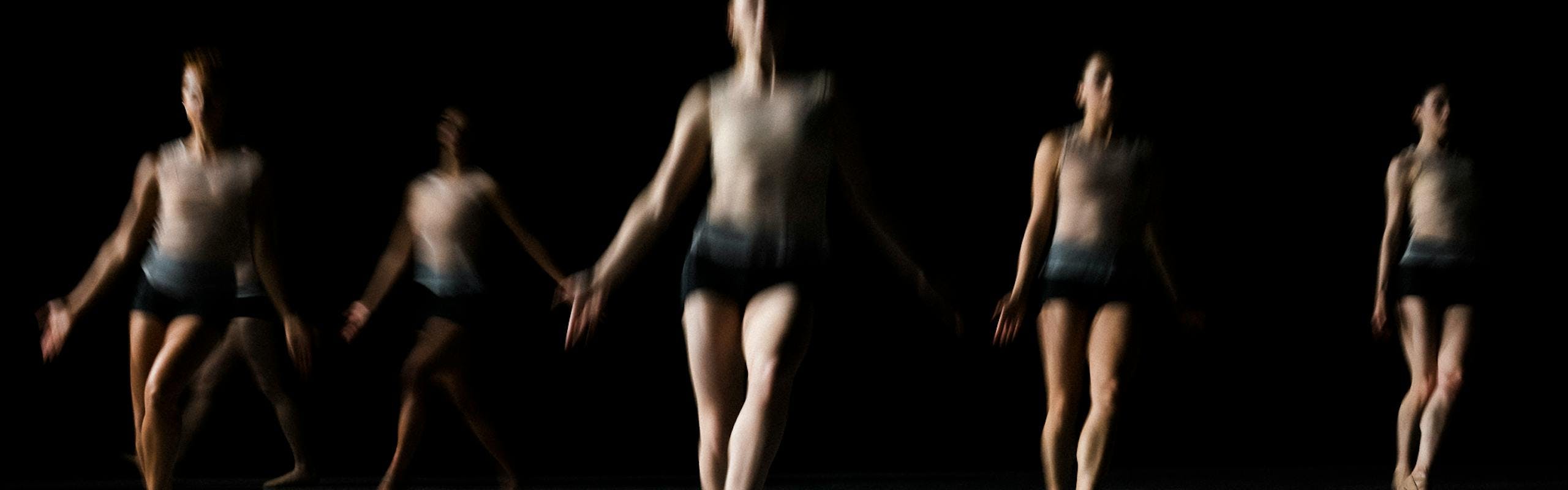 A group of dancers in a blurry image.
