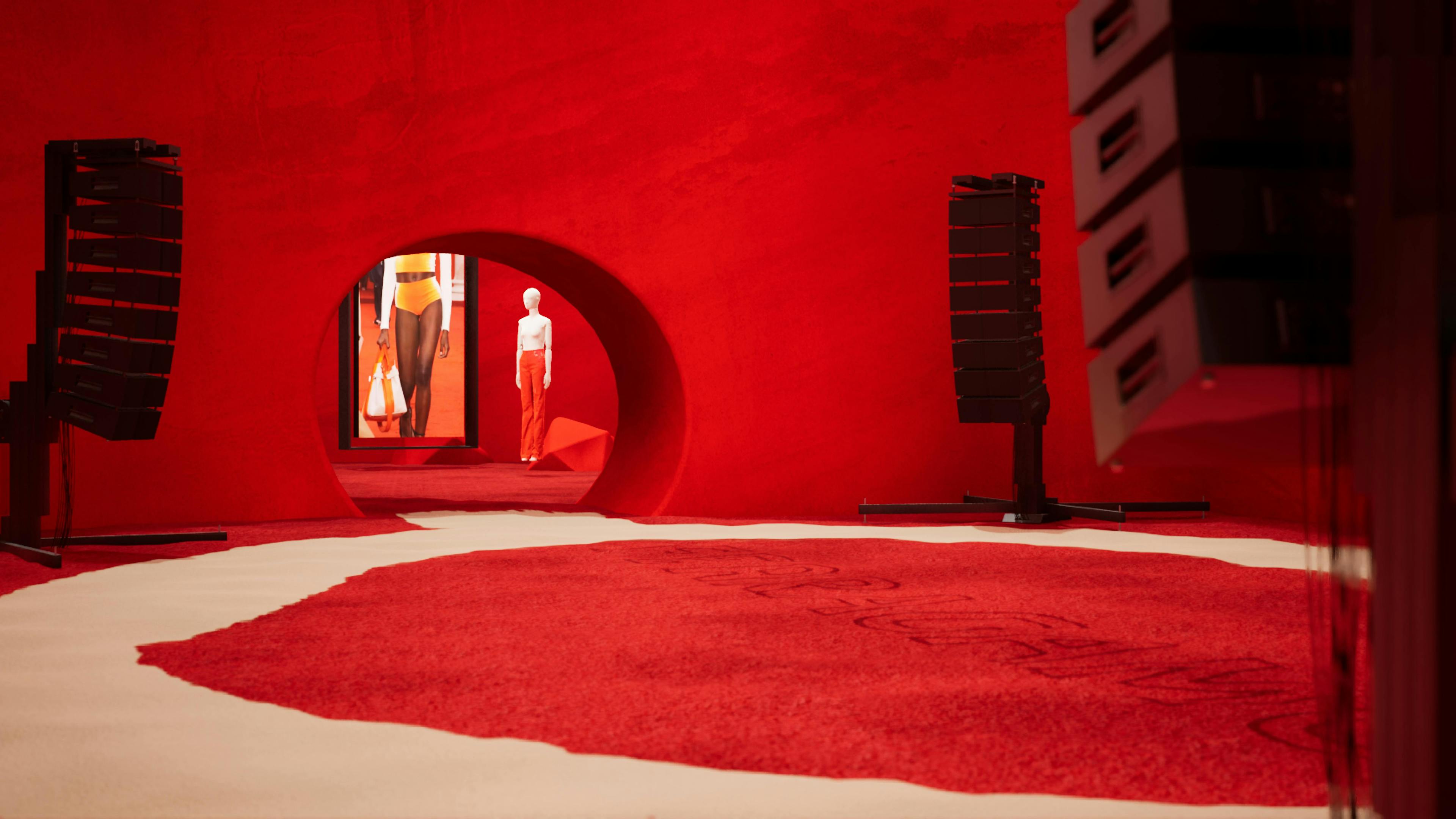 A runway with white marble, red carpet, and manequin in red pants in a red room