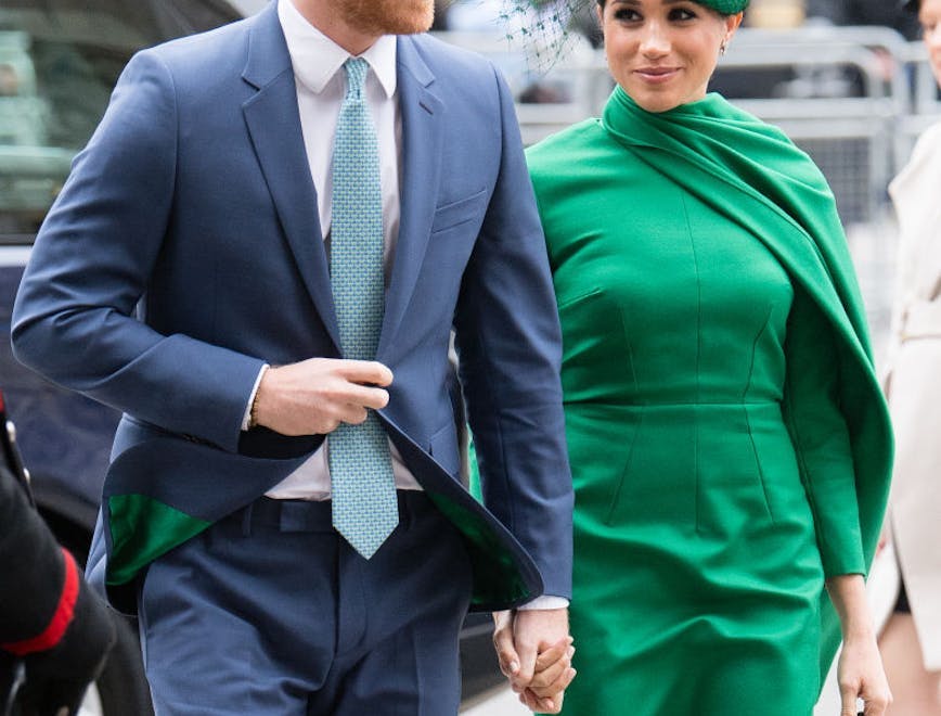 A man in a blue suit next to a woman in a green dress.