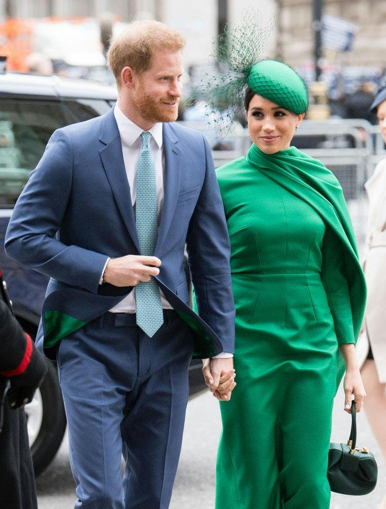 A man in a blue suit next to a woman in a green dress.