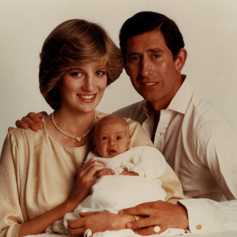 diana and charles holding baby