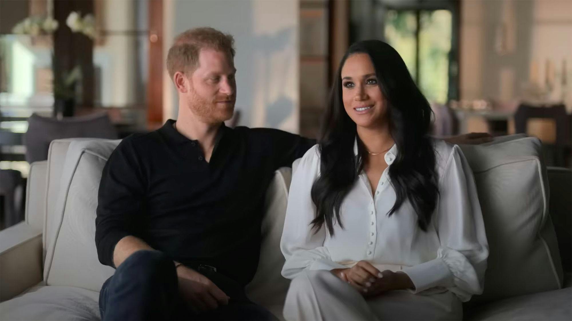 Prince Harry and Meghan Markle sitting on a couch