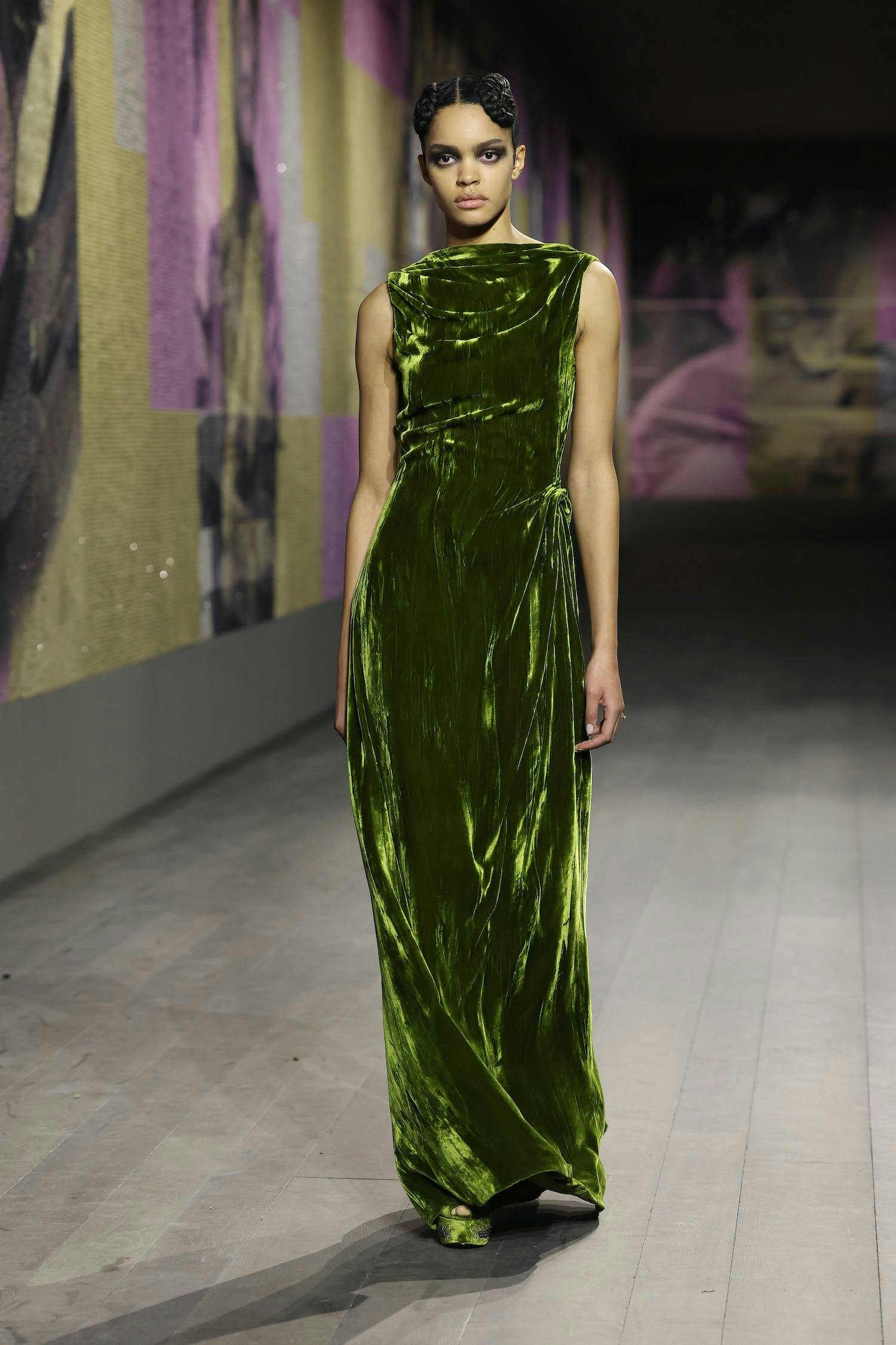 Model wears velvet green, high-neck dress.
