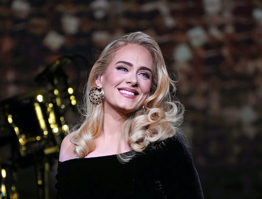 Adele wearing a black, embelished Schiaparelli gown.