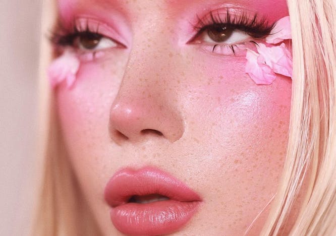 Girl wears pink eyeshadow and lipstick.